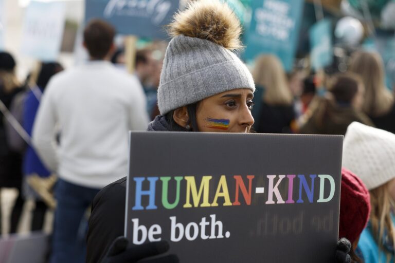 A LGBTQ+ rights supporter demonstrates in front of the U.S. Supreme Court Building on Dec. 5, credit Anna Moneymaker, Getty Images