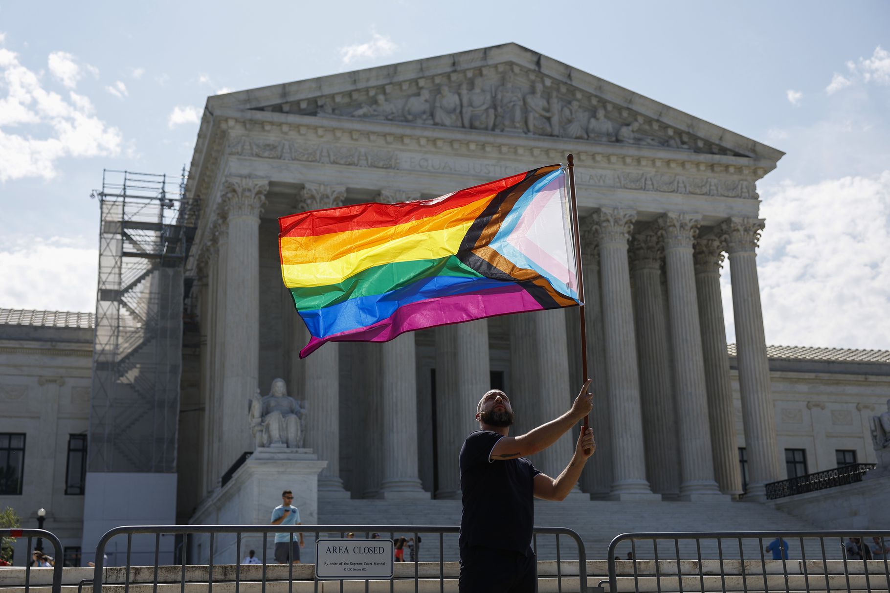 A same-sex marriage supporter waves an LGBTQIA Pride flag in front of the US Supreme Court, credit Anna Moneymaker, Getty Images