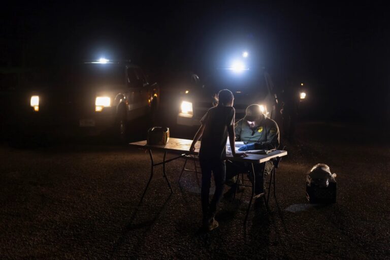 An unaccompanied migrant child seeking asylum, is registered by a border patrol agent after she crossed the Rio Grande, Photo by Adrees Latif, Reuters