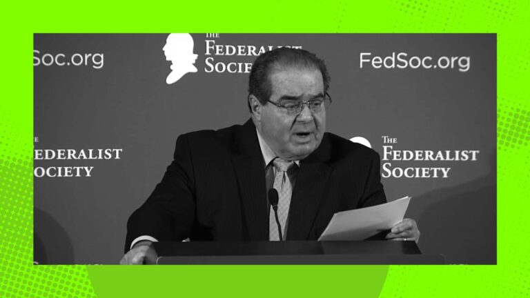 Justice Scalia at a podium, credit Balls and Strikes