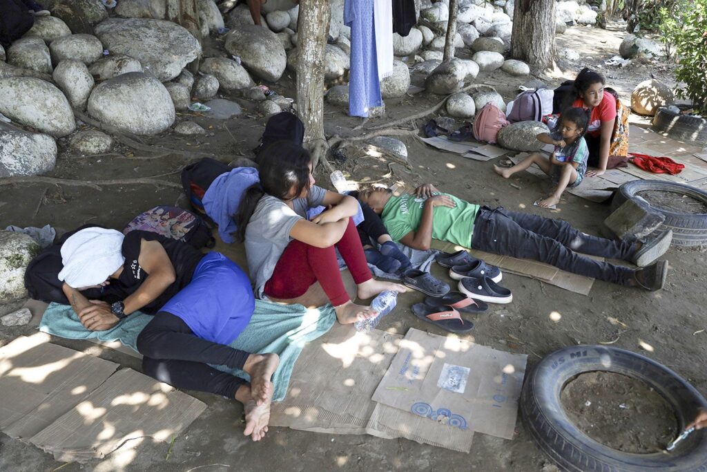 Migrants rest near the Suchiate River, credit Jose Torres, Anadolu via Getty Images