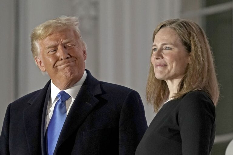 Newly appointed Justice Amy Coney Barrett stands with the man who put her on the Supreme Court, credit Getty Images