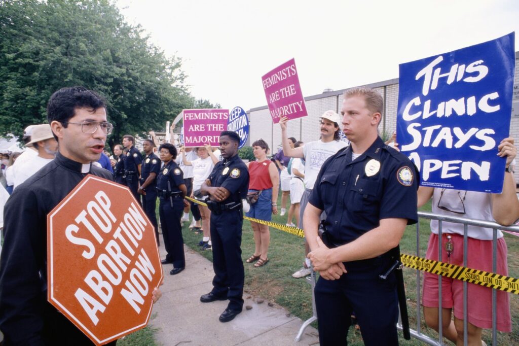 Police stand guard between a group of anti-abortion protesters and a group of pro-choice protesters outside a clinic in Little Rock, Arkansas. Greg Smith, CORBIS, Corbis via Getty Images