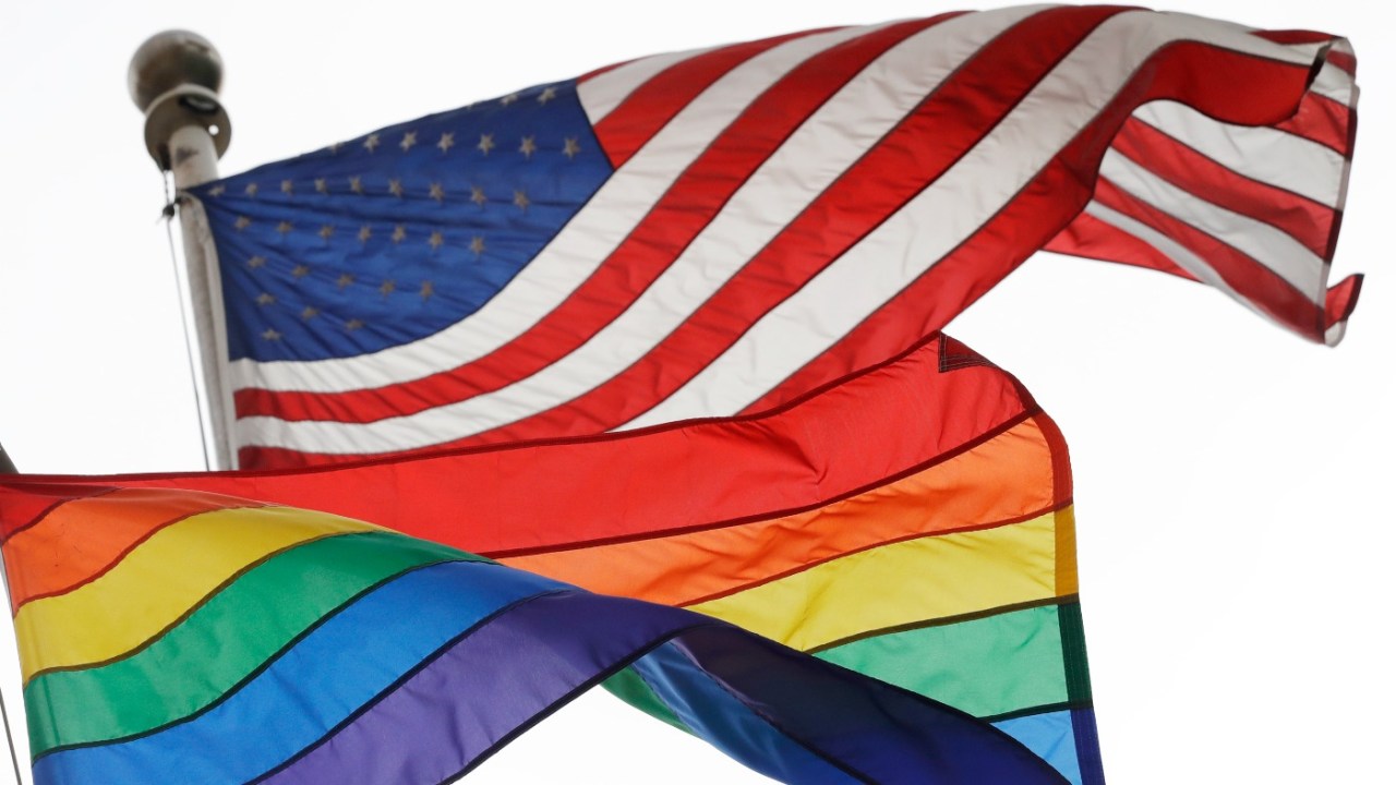 Rainbow and American flags, credit AP Photo, Mark Lennihan, File