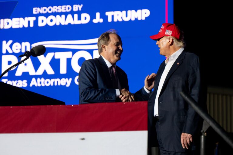 Texas Attorney General Ken Paxton greets former President Donald Trump at a 2022 rally, Brandon Bell, Getty Images