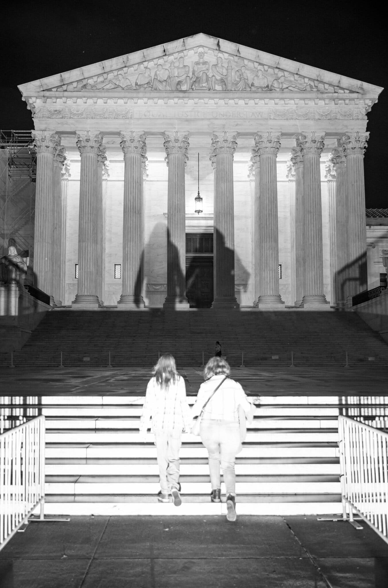 Two women walk up the steps of the Supreme Court building, credit Damon Winter, The New York Times