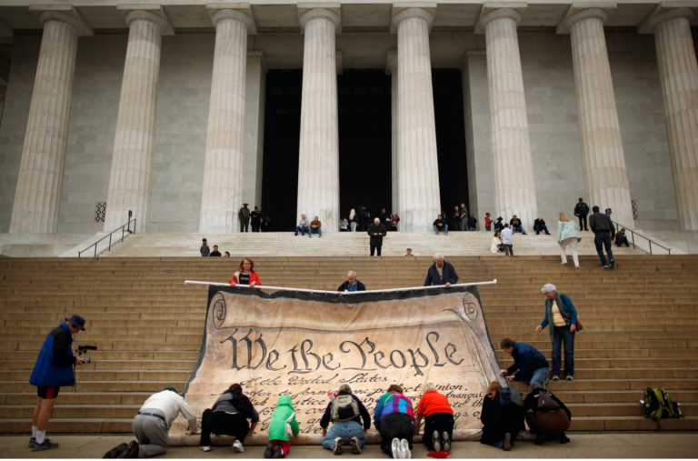 Volunteers help roll up a giant banner printed with the Preamble to the United States Constitution during a demonstration at the Supreme Court CHIP SOMODEVILLA:GETTY IMAGES