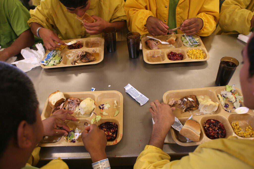 inmates eating from trays